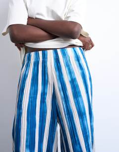 Model wearing Stripe crinkle wide leg trousers in navy
