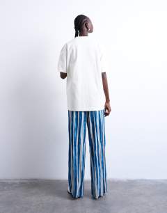 Model wearing Stripe crinkle wide leg trousers in navy