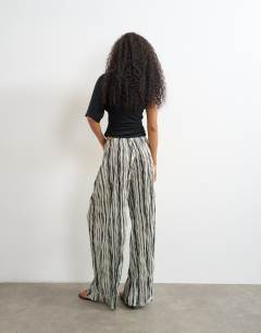 Model wearing Stripe drawstring crinkle trouser in black