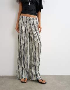 Model wearing Stripe drawstring crinkle trouser in black