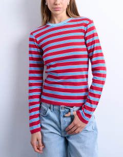Model wearing Stripe long sleeve everyday tee in red and blue