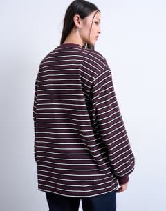 Model wearing Stripe long sleeve slouchy skater tee in burgundy