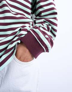 Model wearing Stripe long sleeve slouchy skater tee in mint and burgundy