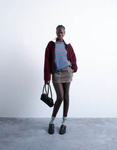 Model wearing Stripe oversized deep cuff sweat in blue and burgundy
