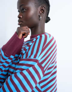Model wearing Stripe oversized deep cuff sweat in blue and burgundy