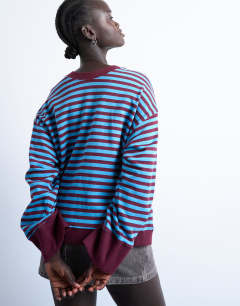 Model wearing Stripe oversized deep cuff sweat in blue and burgundy