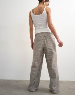 Model wearing Stripe poplin wrapover skirt trouser in brown