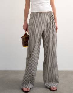 Model wearing Stripe poplin wrapover skirt trouser in brown