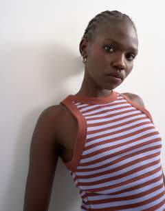 Model wearing Stripe rib racer vest in brown
