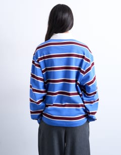 Model wearing Stripe rugby long sleeve polo top in blue