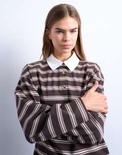 Model wearing Stripe rugby long sleeve polo top in chocolate