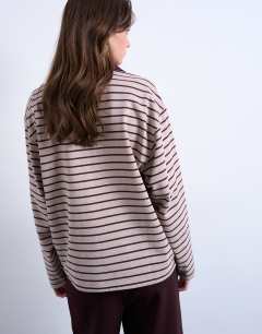 Model wearing Stripe rugby long sleeve polo top in oat and burgundy