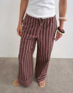 Model wearing Stripe tie waist wide leg trouser in brown and pink