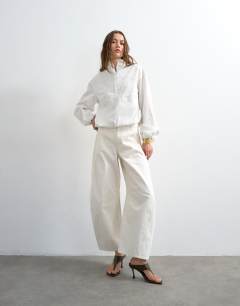 Model wearing Stripe zip long sleeve cuffed top in white