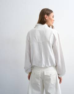 Model wearing Stripe zip long sleeve cuffed top in white