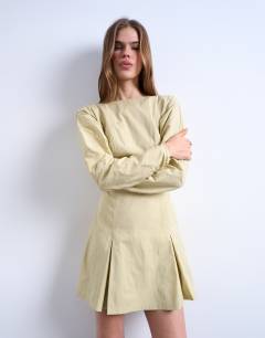 Model wearing Structured flippy hem mini dress in buttermilk