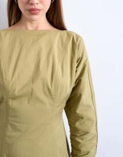 Model wearing Structured flippy hem mini dress in olive