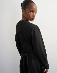 Model wearing Structured midi dress with tie waist detail and batwing sleeve
