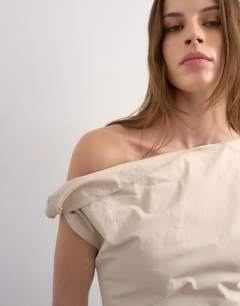 Model wearing Structured mini dress with twist shoulder in off white