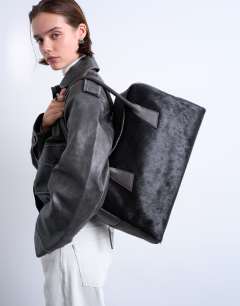 Model wearing Suki hair on real leather shoulder bowler bag in chocolate