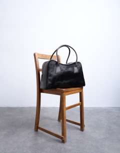 Model wearing Suki hair on real leather shoulder bowler bag in chocolate