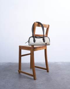 Model wearing Sullivan hair on real leather shoulder bowler bag in cow print 