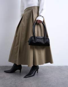 Model wearing Sullivan leather shoulder bowler bag in black pony