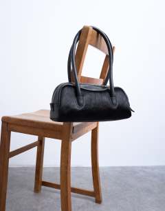 Model wearing Sullivan leather shoulder bowler bag in black pony