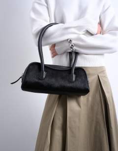 Model wearing Sullivan leather shoulder bowler bag in black pony