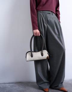 Model wearing Sullivan real leather shoulder bowler bag in cow print pony
