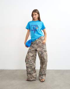 Model wearing Topshop 'Sun Club' graphic oversized t-shirt in cream