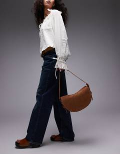 Model wearing Sunday real leather suede shoulder bag in tan