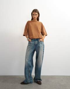 Model wearing Topshop 'Sundream' graphic embroidered detail oversized t-shirt in brown