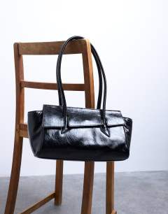 Model wearing Sunny shoulder bag with asymmetric flap in black