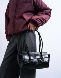 Model wearing Sunny shoulder bag with asymmetric flap in black