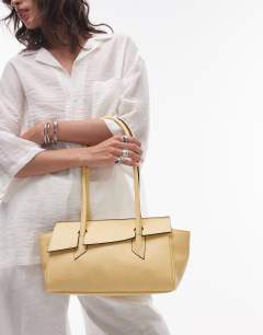 Model wearing Sunny shoulder bag with asymmetric flap in lemon