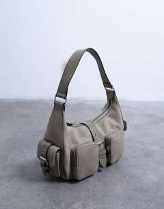 Model wearing Sunrise pocket shoulder suede bag in taupe