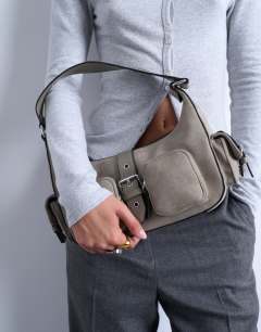 Model wearing Sunrise pocket shoulder suede bag in taupe