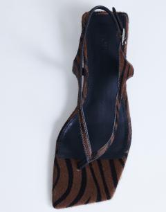 Model wearing Sunshine toe thong mid heel sandal in brown zebra hair on real leather 