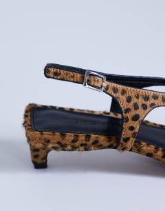 Model wearing Sunshine toe thong mid heel sandal in deer print hair on real leather 