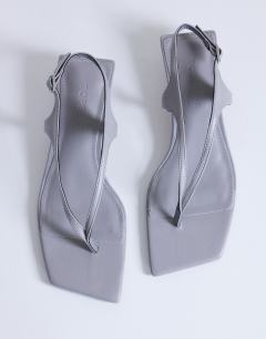 Model wearing Sunshine toe thong mid heel sandal in grey hair on real leather