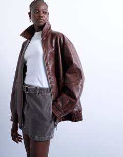 Model wearing Super oversized faux leather contrast heavy wash bomber jacket in brown