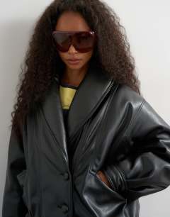 Model wearing Super oversized faux leather shawl collar bomber jacket in black