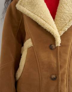 Model wearing Super oversized faux shearling short jacket in beige