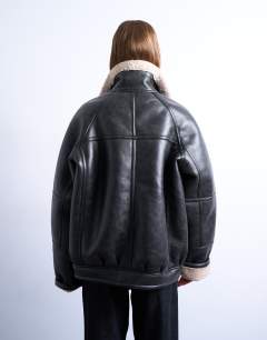 Model wearing Super oversized vintage wash shearling aviator bomber in black