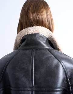 Model wearing Super oversized vintage wash shearling aviator bomber in black