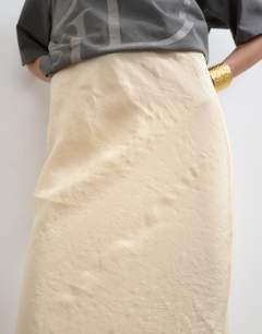 Model wearing Super soft cupro bias midi in buttermilk