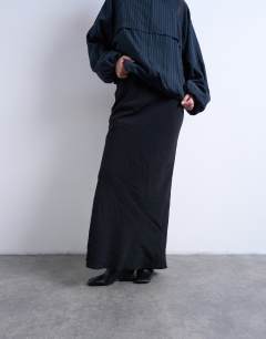 Model wearing Super soft cupro bias midi skirt in charcoal