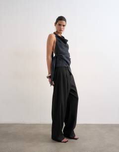 Model wearing Super soft cupro halter neck in black