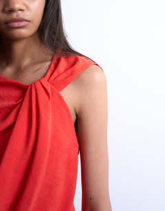 Model wearing Super soft cupro knot detail top in red